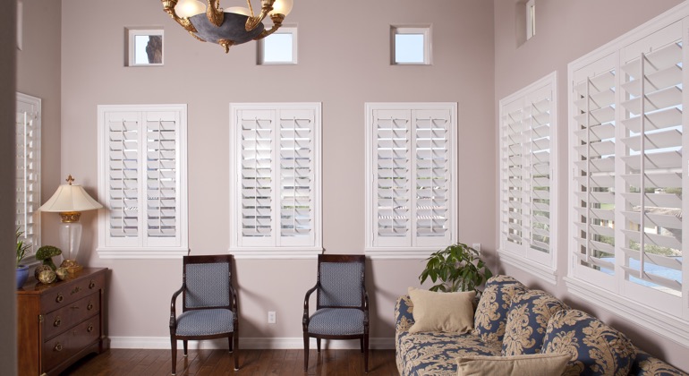 Chic sunroom with casement shutters