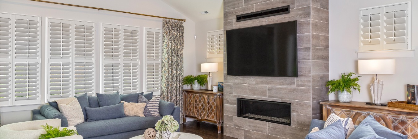Plantation shutters in Millburn family room with fireplace