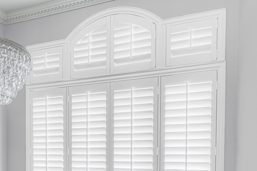 Customize your Palladian windows with white Polywood shutters in New Brunswick. White Polywood Palladian windows in a dining room.