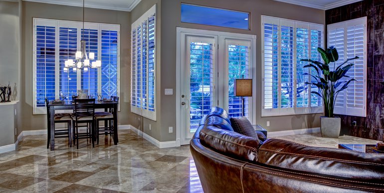 Photo Courtesy of Room Resolutions New Brunswick great room with white shutters and tile floor.
