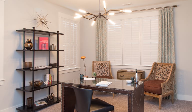 Picking the right window treatments can result in an increase in natural light. New Brunswick home office with plantation shutters.