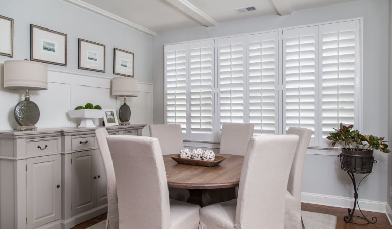 Plantation shutters are a perfect choice for homeowners looking for privacy or natural light. Plantation shutters in a New Brunswick dining room.