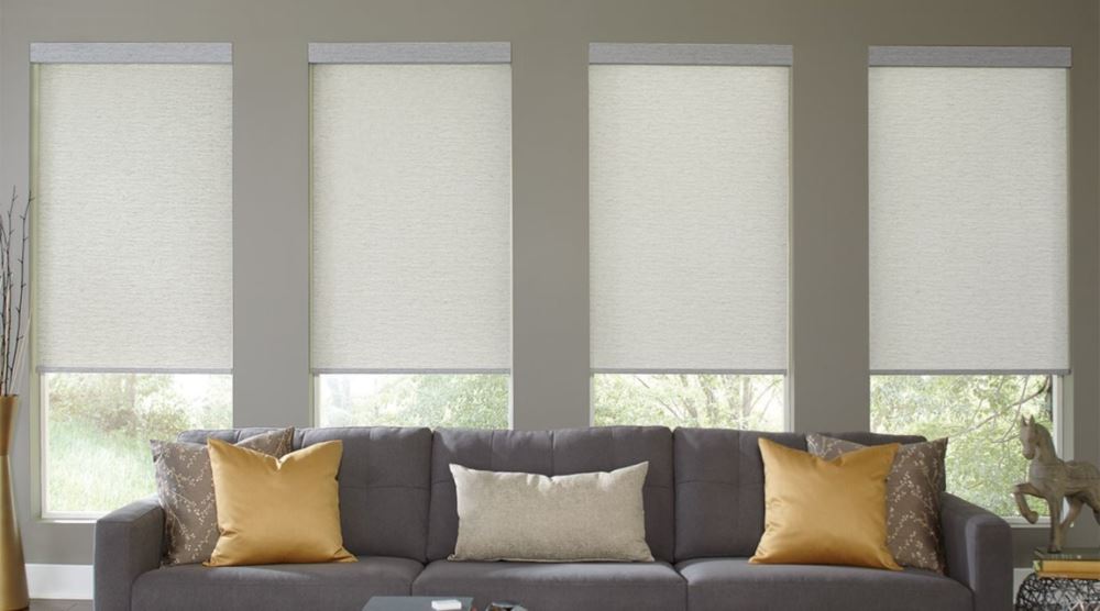 Many cordless shades can be operated using a remote control or an app. Motorized cordless window treatments above a couch