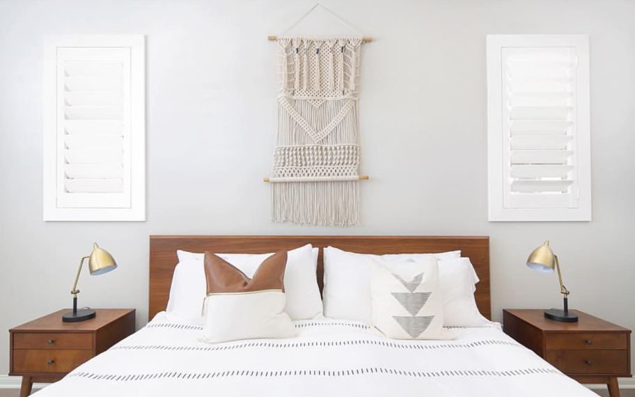 Custom-fitted louvered shutters provide excellent nighttime privacy in New Brunswick. Photo Credit: Audrey Crisp Louvered shutters in a bedroom.