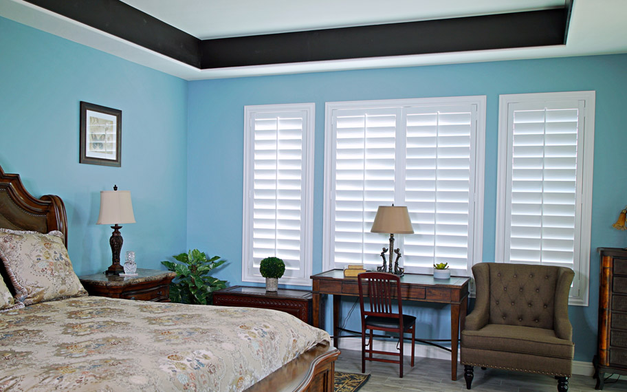 Polywood shutters provide insulation for the perfect temperature all year long in New Brunswick. Polywood shutters in a bedroom.