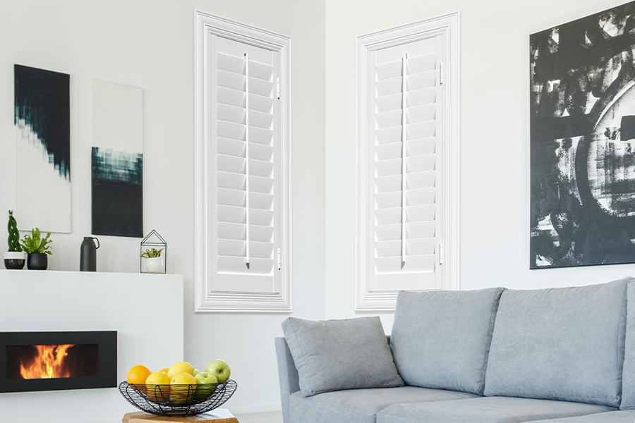 White Polywood shutters add character and class in New Brunswick. White polywood shutters in a corner of a modern living room.