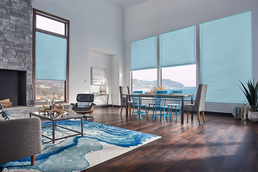 Smart motorized window shades are perfect on tall windows in your New Jersey home. Blue motorized shades on tall living room windows