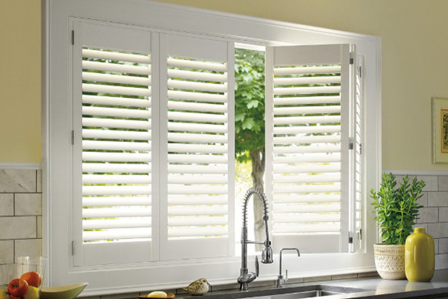 Polywood shutters are built to withstand the test of time in New Brunswick. White Polywood shutters above a kitchen sink.